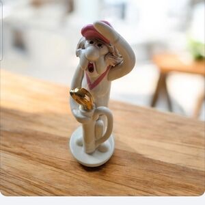 This is a Tweeples World ceramic lady golfer figurine,  artist Joe Peck